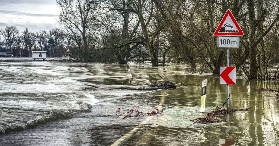 flooded road with road sign