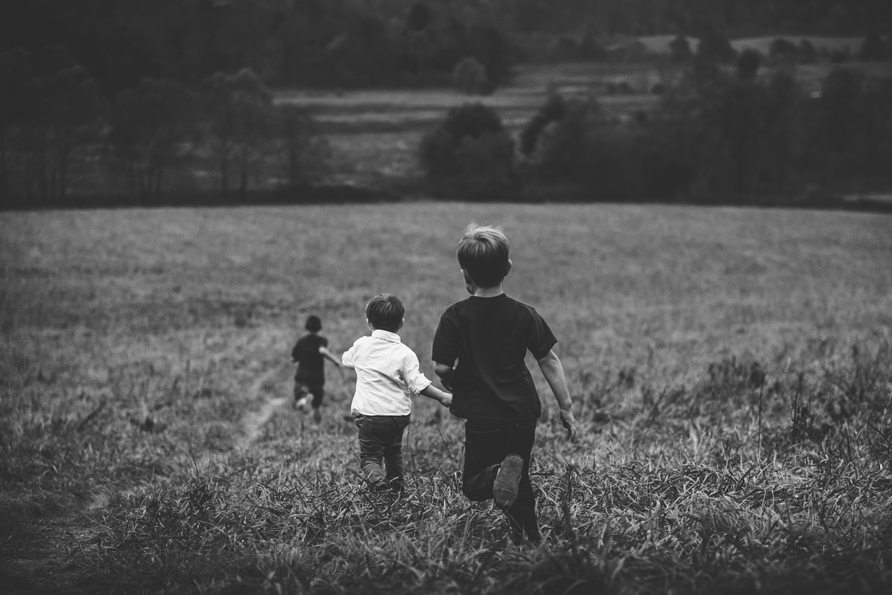 three-boys-running-in-field