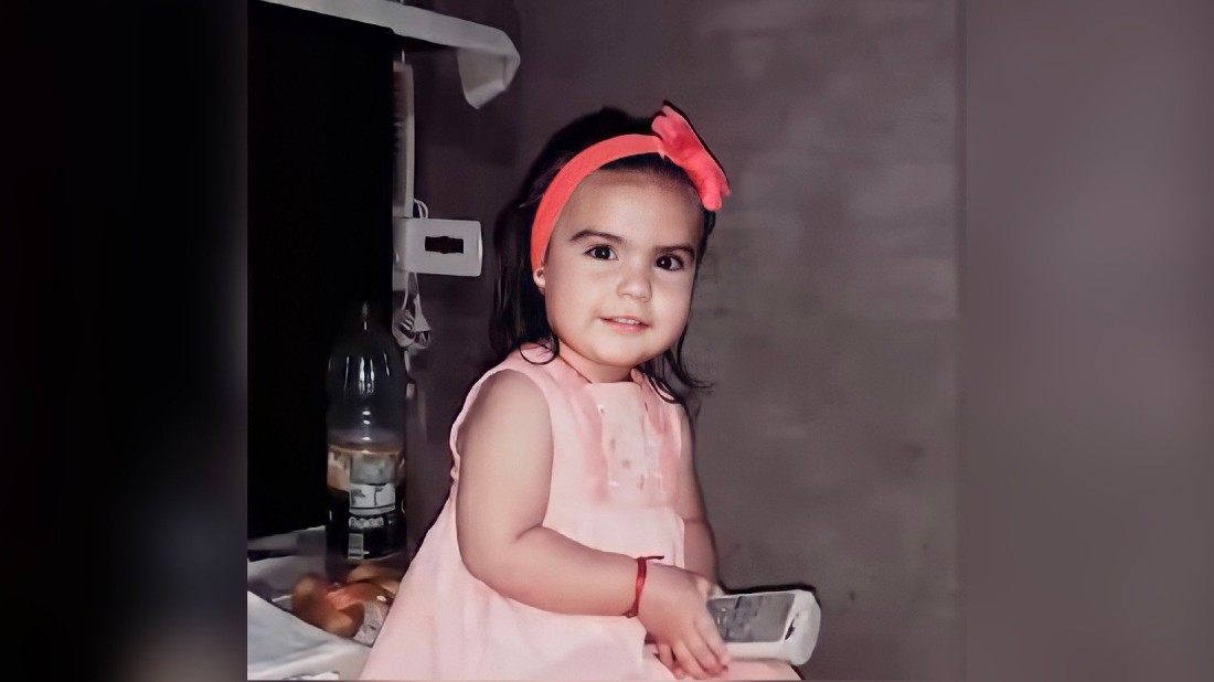 seated 3 year old in pink dress