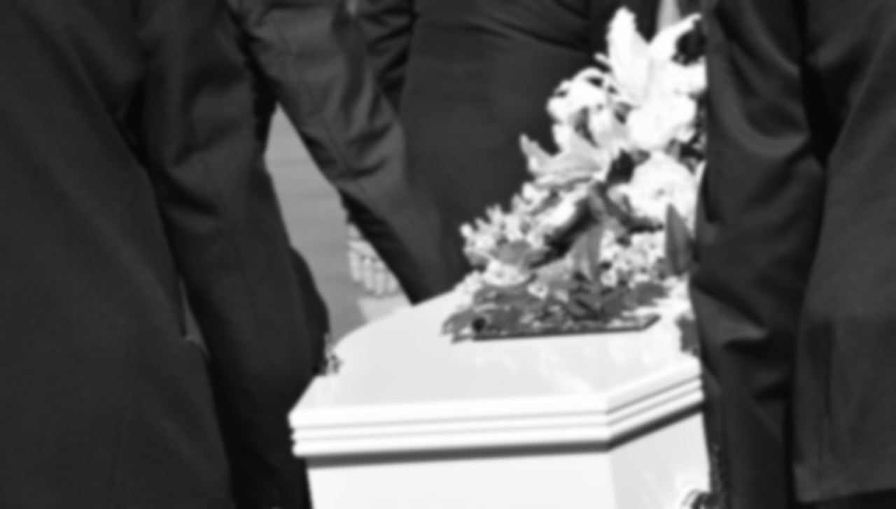 casket flowers and pall bearers