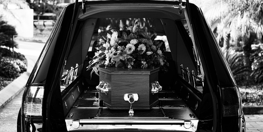 hearse with casket and flowers