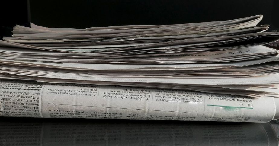 stack of folded newspapers