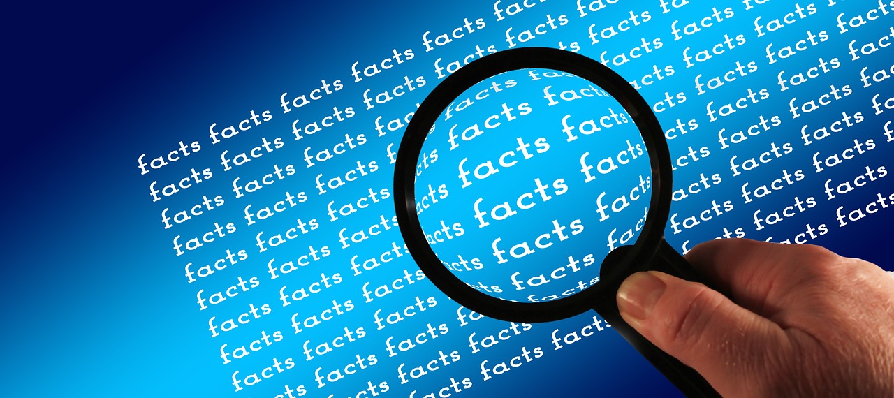 magnifying glass checking facts